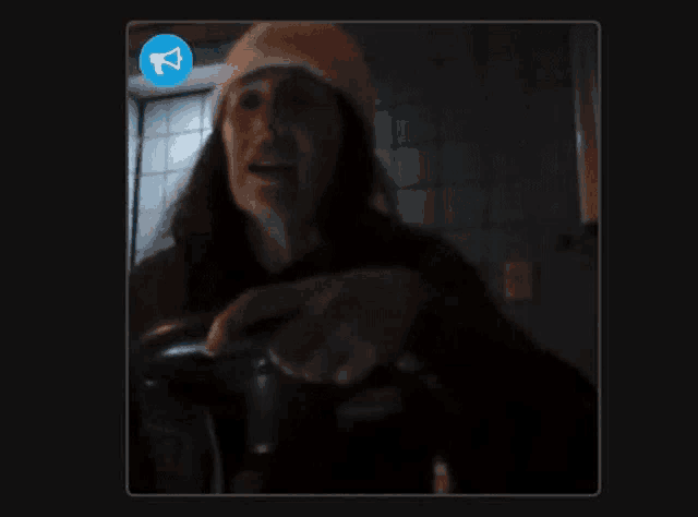 a blurred image of a person taking a picture with a megaphone icon