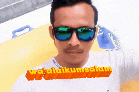 a man wearing sunglasses and a white shirt with the words wa alaikumsalam