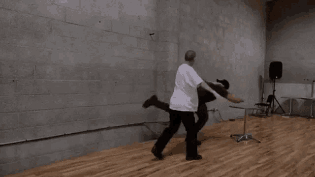 a man in a white shirt with a skull on it is dancing