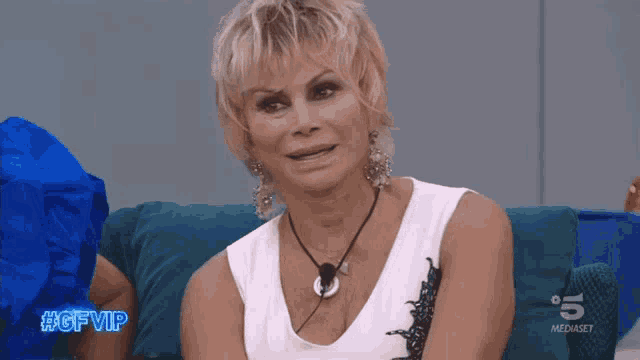 a woman sitting on a couch with the hashtag #gfvip on the bottom right