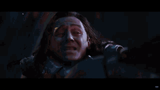 a close up of a man 's face with the words loki death scenes at the top