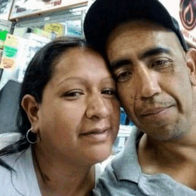 a man and a woman are posing for a selfie together .