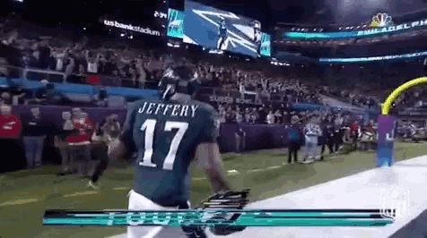 a football player in a green jersey with the number 17 on it