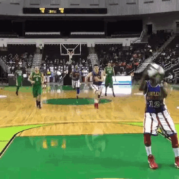 a basketball player wearing number 12 throws a basketball