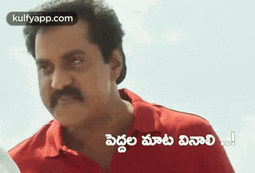 a man with a mustache is wearing a red shirt and a foreign language .