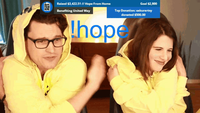 a man and a woman are hugging in front of a screen that says hope on it