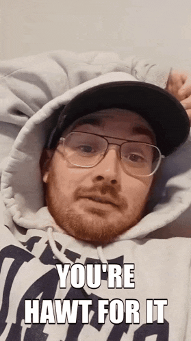 a man wearing glasses and a hat with the words you 're hawt for it above him