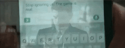 a person is typing on a cell phone with a picture of a man in a suit .