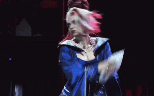 a woman with red and white hair is wearing a blue kimono