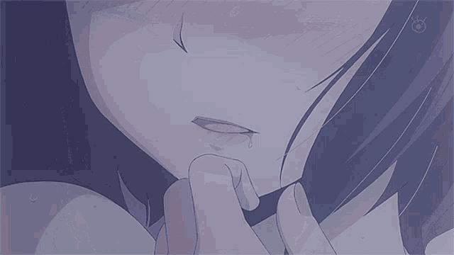 a close up of a girl 's eyes with a tear coming out of her eye
