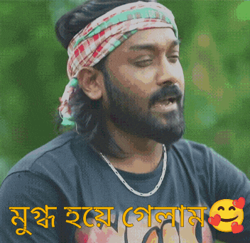 a man with a beard is wearing a headband and a necklace and has a smiley face on his shirt