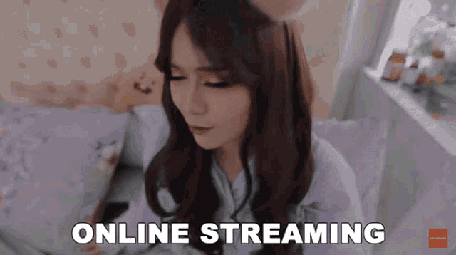 a woman laying on a bed with her eyes closed and the words " online streaming " below her