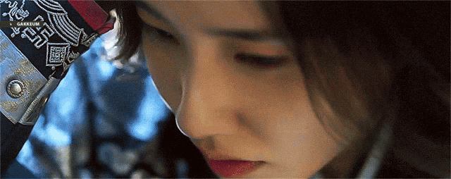 a close up of a woman 's face with a bandana on her head with chinese writing
