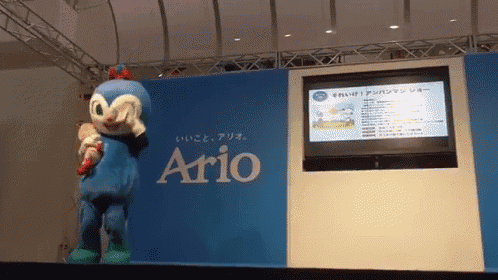 a mascot stands in front of a sign that says " ario "
