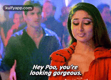 a woman in a red dress says hey poo , you 're looking gorgeous