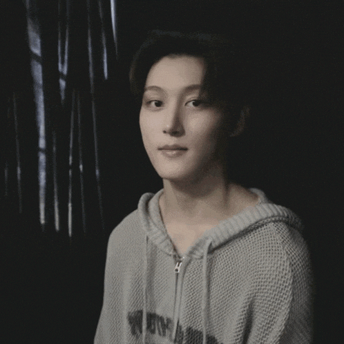 a young man wearing a sweater that says ' no room ' on it