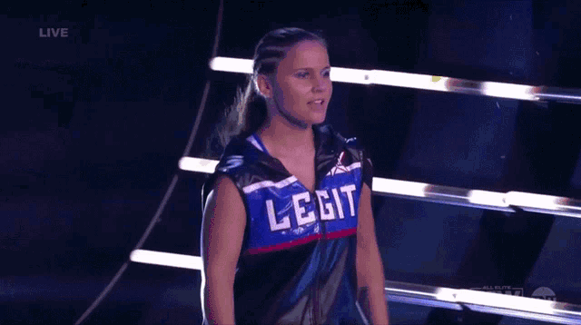 a woman wearing a vest that says legit