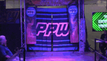 a man sits in front of a stage that says ppw on it