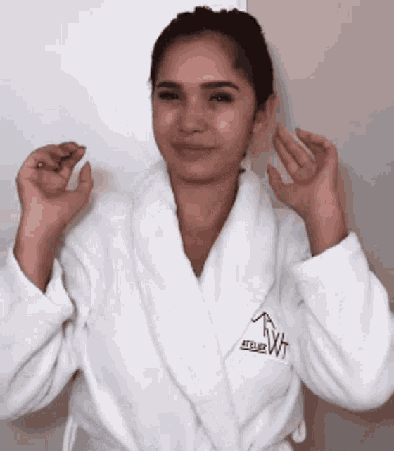 a woman wearing a white robe that says ' tb2wt ' on it