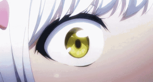 a close up of a girl 's eye with a yellow pupil