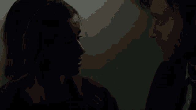 a man and a woman are looking into each other 's eyes