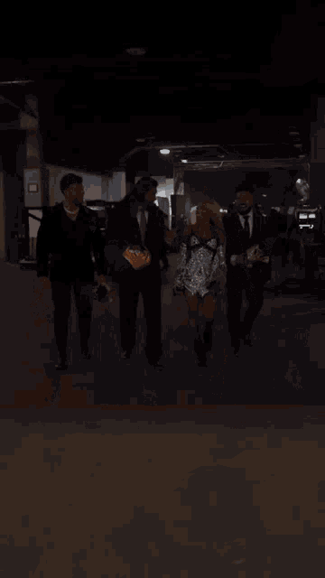 a man in a suit and tie is holding the hand of a woman in a short dress