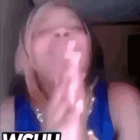 a blurry photo of a woman with the word wow on the bottom right