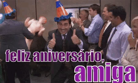 a man wearing a party hat gives a thumbs up in front of a crowd
