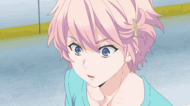 a girl with pink hair and blue eyes is wearing a light blue shirt