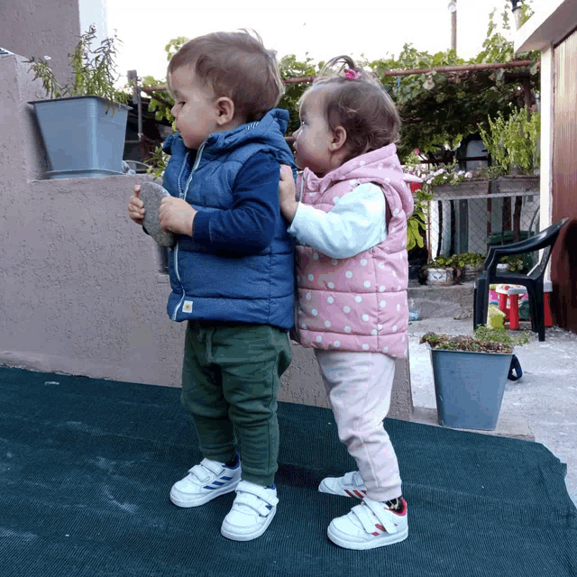 a boy and a girl stand next to each other
