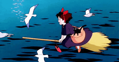 a girl is riding a broom with a cat on it .