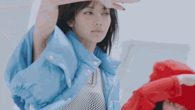 a woman in a blue jacket is standing next to a woman in a red shirt