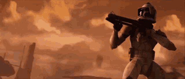 a star wars clone trooper is holding a gun in his hand .