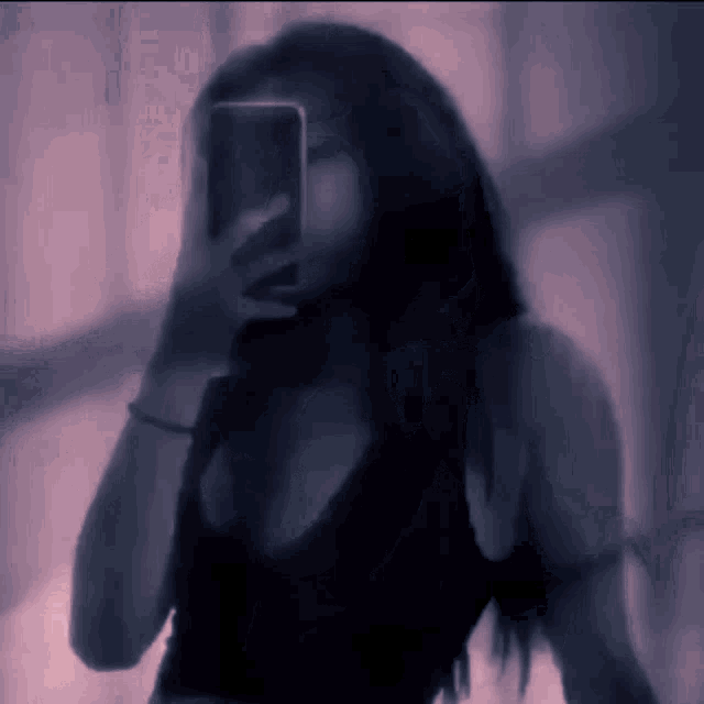 a woman is taking a selfie with her cell phone
