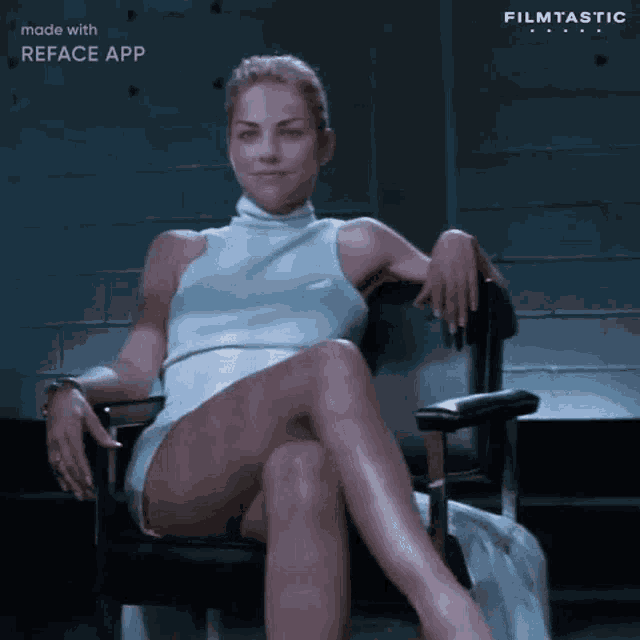 a woman in a white dress is sitting in a chair with her legs crossed and her hands on her knees .