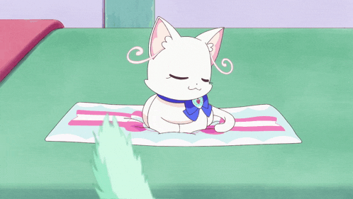 a white cat with blue eyes sits on a striped towel