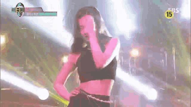 a woman in a crop top is dancing on a stage