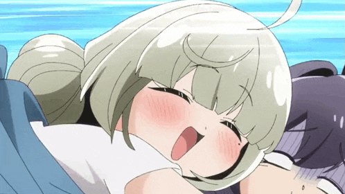 a girl with blonde hair is laying on another girl