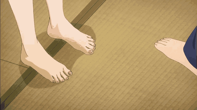 a man and a woman 's bare feet are standing on a mat