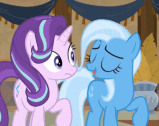 a couple of ponies are standing next to each other and looking at each other