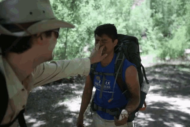 a man wearing a blue shirt that says ' sierra club ' on the front