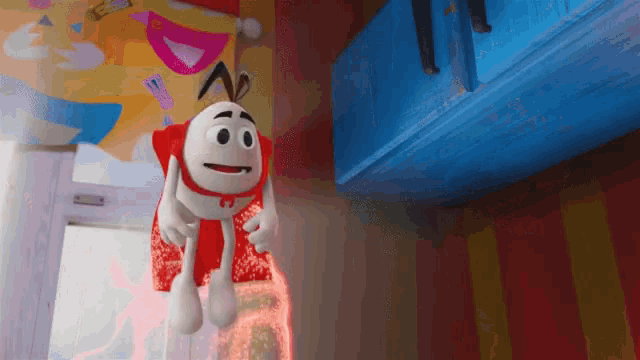 a cartoon character is hanging from a blue box in a room