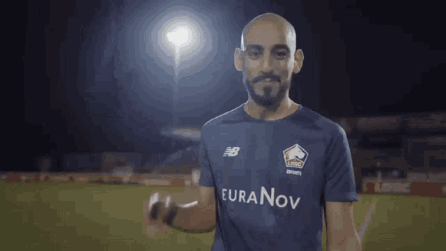 a man with a beard wears a blue shirt that says euranov on it
