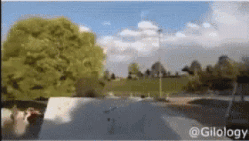 a skateboarder is doing a trick on a ramp in a park