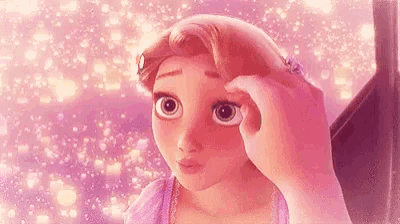 a close up of a person touching a cartoon character 's face .