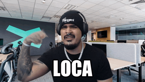 a man wearing a black beanie and headphones says loca