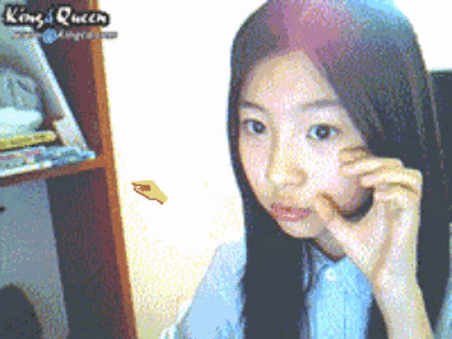 a pixelated image of a girl with king queen written on the bottom right