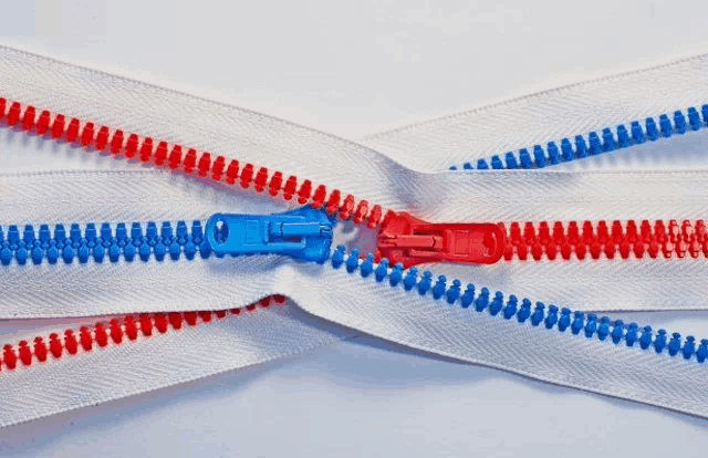 a white zipper with red and blue zipper pulls on it