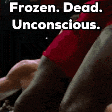 a shirtless man is laying on the ground in a boxing ring with the words frozen dead unconscious .