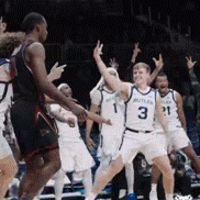 a group of men are playing basketball and one of them is wearing a jersey with the number 3 on it